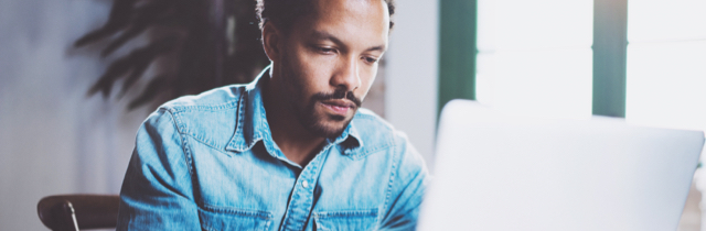 Man using laptop to research federal financial support during COVID-19